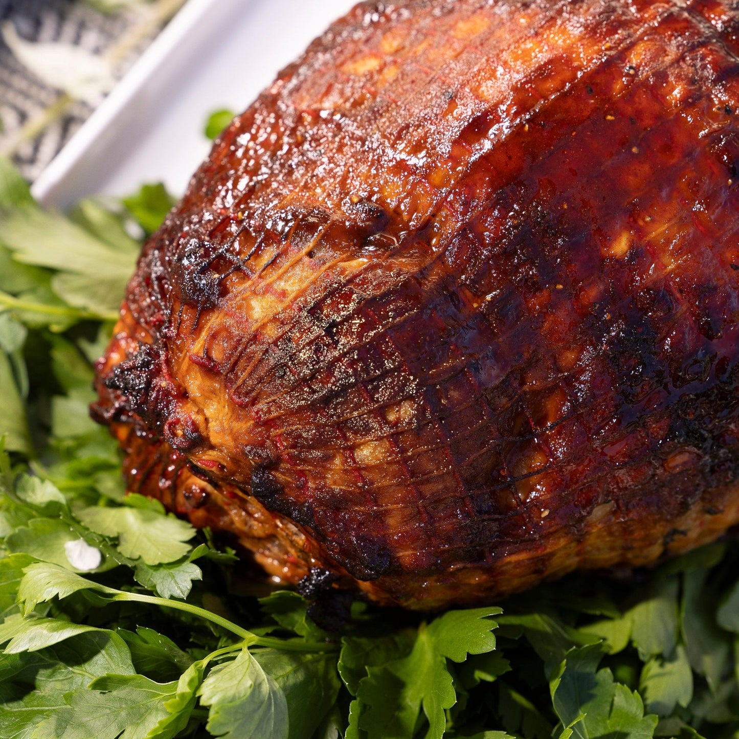 A glazed Turkey breast roll sits on a platter.