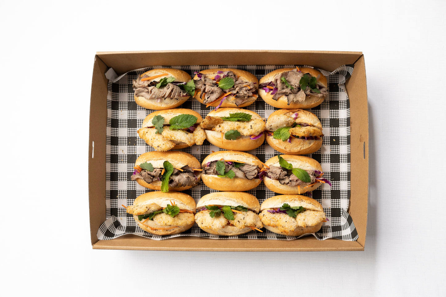 A box of fresh petite rolls with variety of fillings