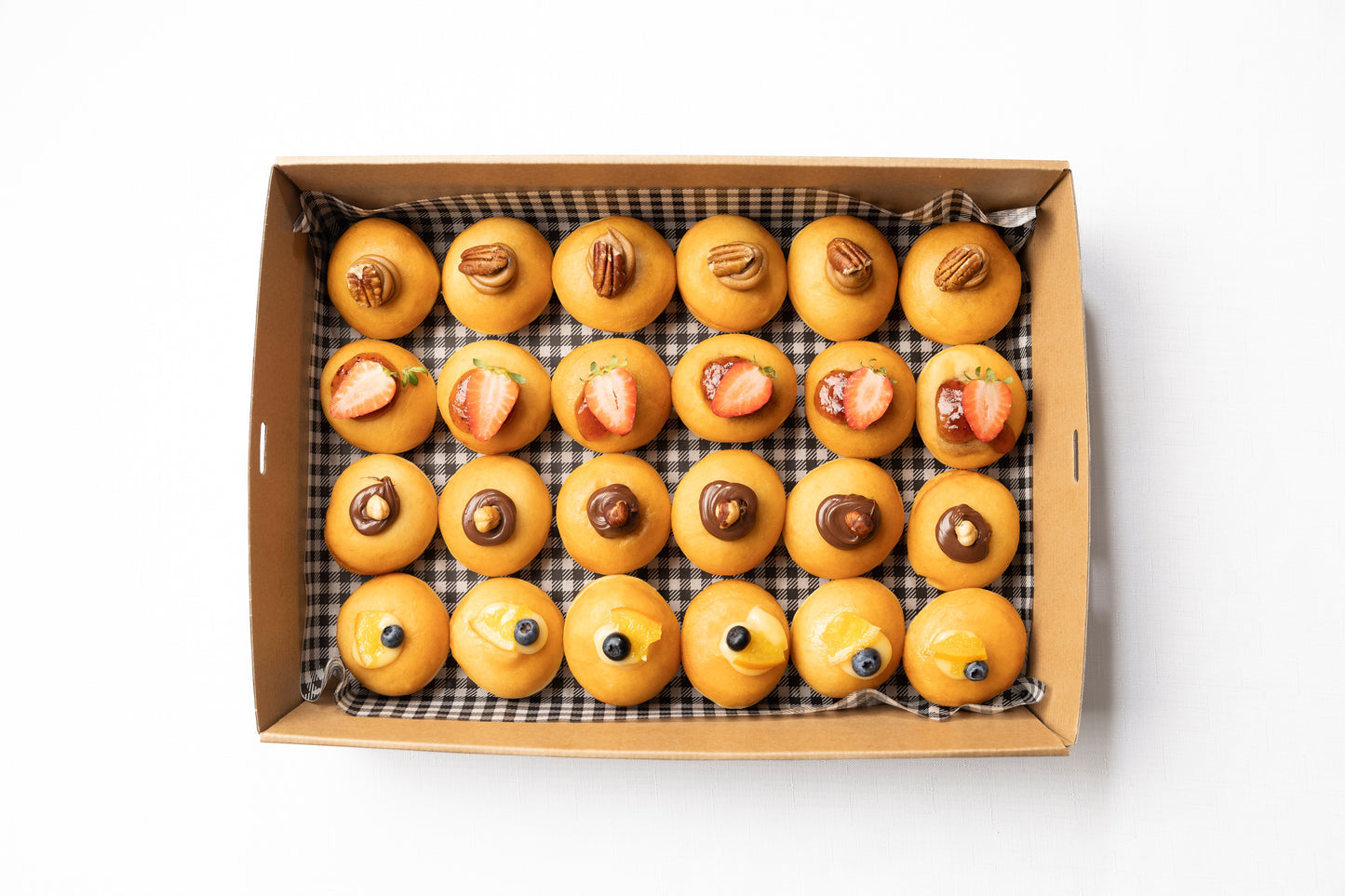 A box of petite donuts in a variety of different flavours