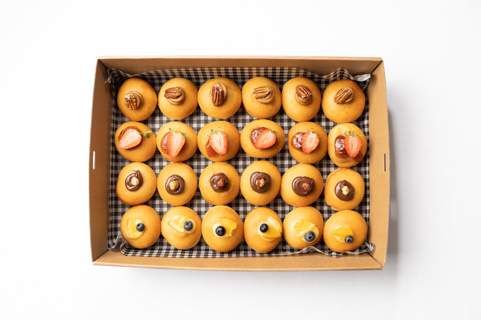 A box of petite donuts in a variety of different flavours